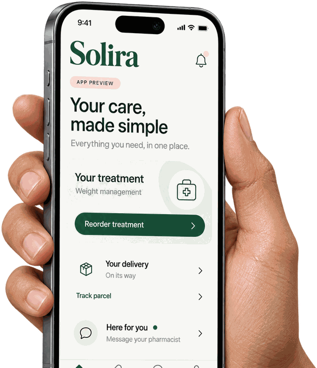 A hand holding a phone showing the Solira app's home screen